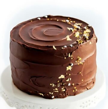 Luxurious Chocolate Cake with Gold Leaf and Star Accents