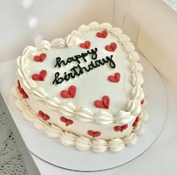 Heart-Shaped Birthday Cake with Red Heart Accent
