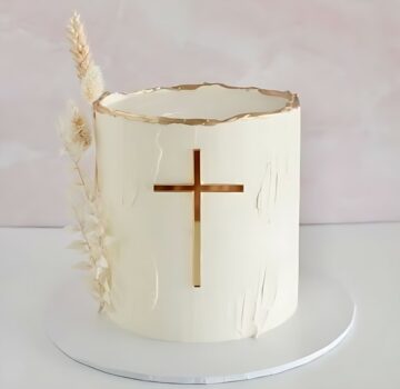Elegant White Cake with Gold Cross Design and Dried Florals