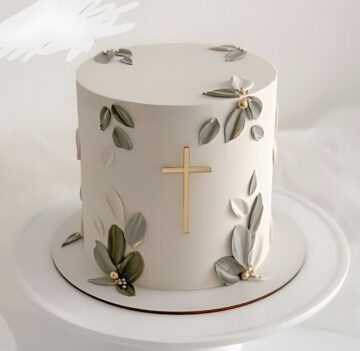 Elegant White Cake with Gold Cross and Leaf Accents