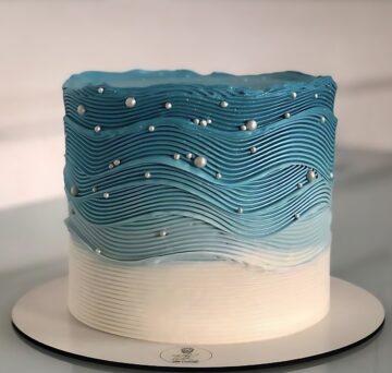 Elegant Blue Ombré Wave Cake with Pearl Accents