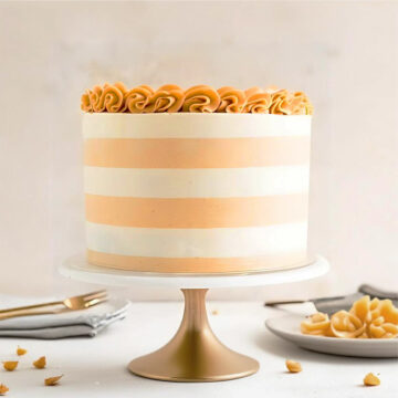 Elegant Beige and White Striped Cake with Rosette Top